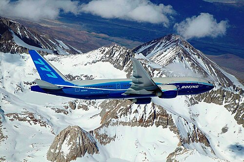 Boeing 777-200LR banking over mountain